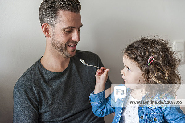 Daughter feeding father