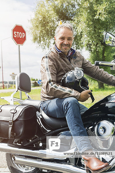 Portrait of man sitting on his motorbike