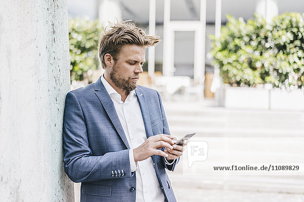 Businessman looking on cell phone