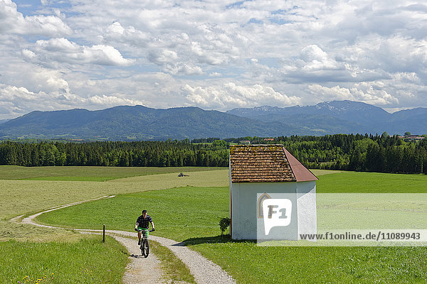 Germany  Bavaria  Faistenberg near Beuerberg  Cyclist at Otthof chapel