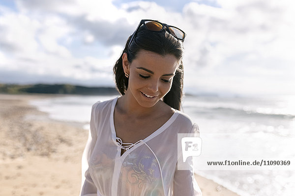 Spain  Asturias  beautiful young woman on the beach
