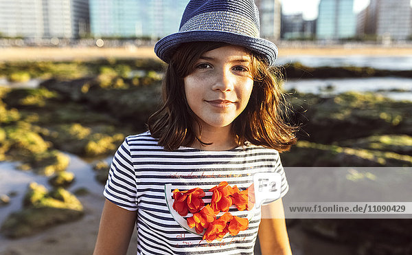 Portrait of a smiling girl on the beach at sunset