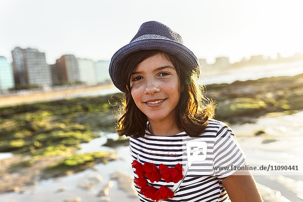 Portrait of a smiling girl on the beach at sunset