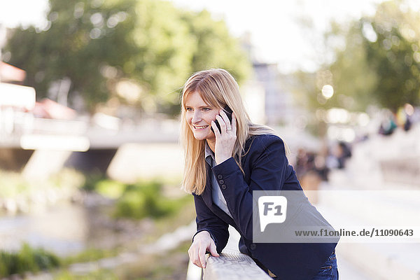 Smiling blond businesswoman on the phone