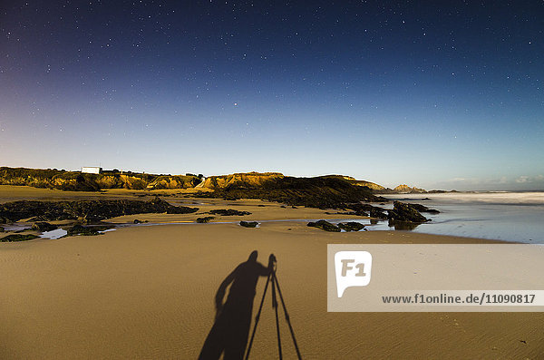 Spain  Galicia  Ferrol  Shadow of a photographer on Playa de Ponzos at night