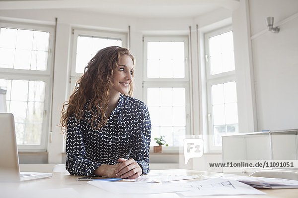 Smiling woman at desk in office