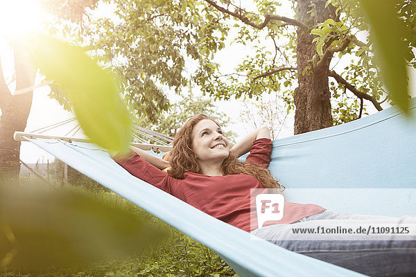 Smiling woman relaxing in hammock