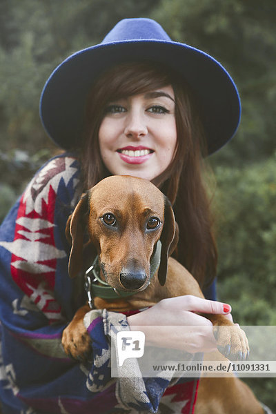 Portrait of happy woman with her dachshund