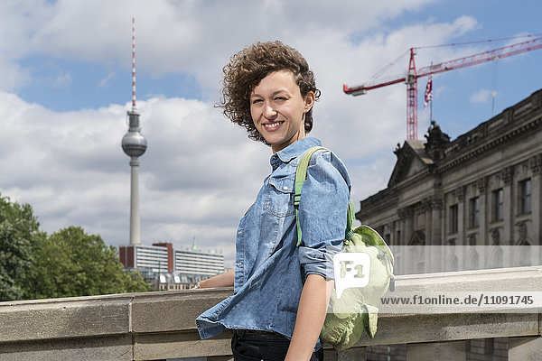 Deutschland  Berlin  Porträt der lächelnden jungen Frau vor dem Bode-Museum
