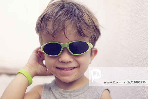 Portrait of smiling little boy wearing sunglasses