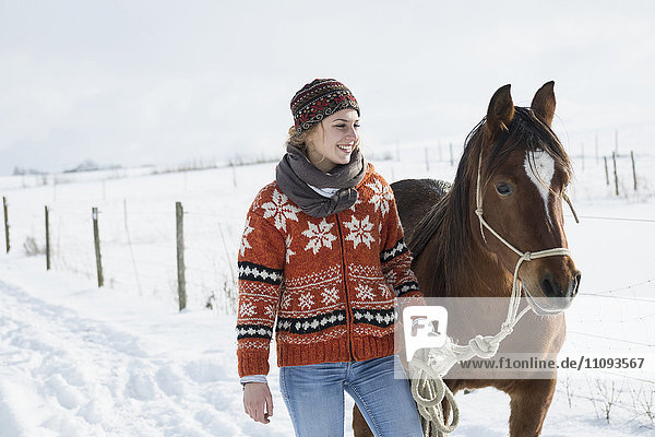 Young woman standing with horse in the farm  Bavaria  Germany