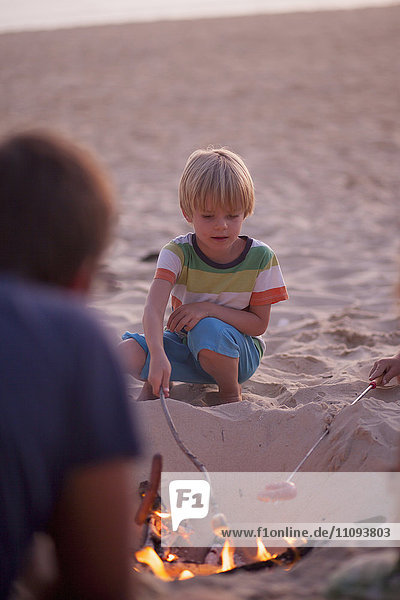 Boy with his family enjoying camping on the beach