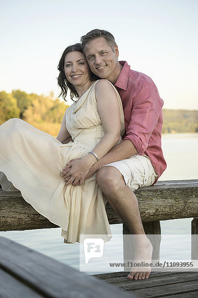 Portrait of mature couple smiling on pier  Bavaria  Germany