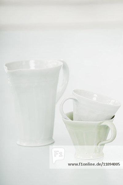 Close-up of white cups and pitcher  Bavaria  Germany