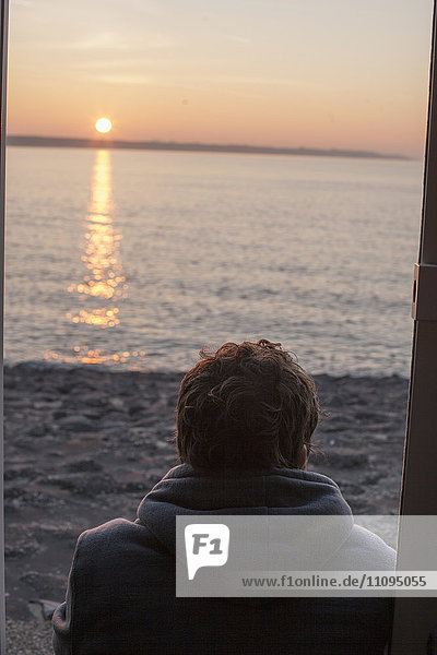 Rear view of a mature man looking sunset on beach  Renesse  Schouwen-Duiveland  Zeeland  Netherlands