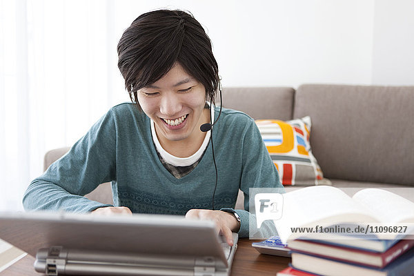 Young Man Playing on Laptop