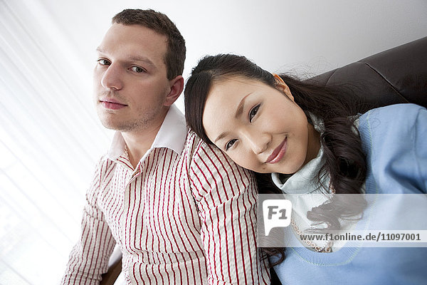 Young Couple Sitting on Sofa