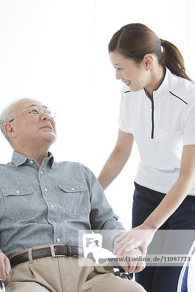 Weibliche Krankenschwester mit älterem männlichen Patienten