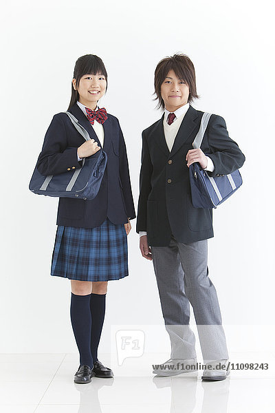 Two High School Students Holding Bags