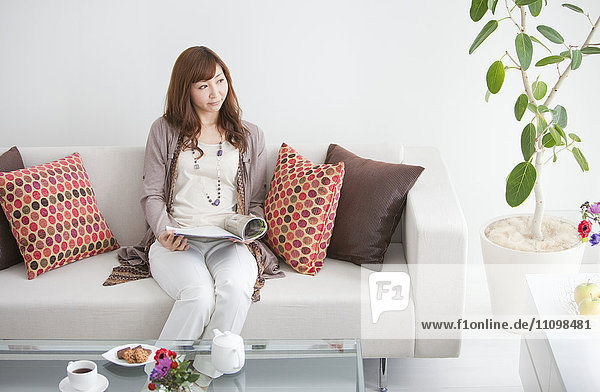 Young Woman Reading in Living Room