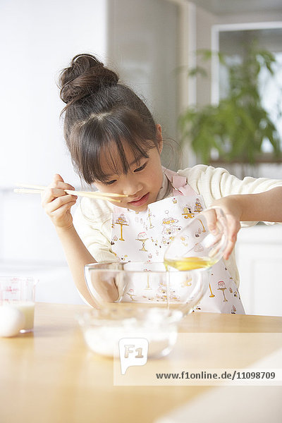 Girl beating egg