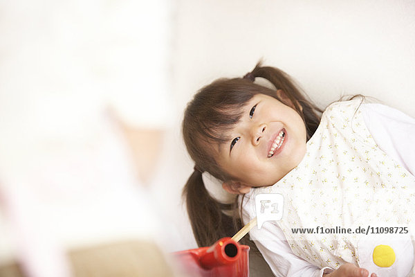 Girl wearing apron smiling