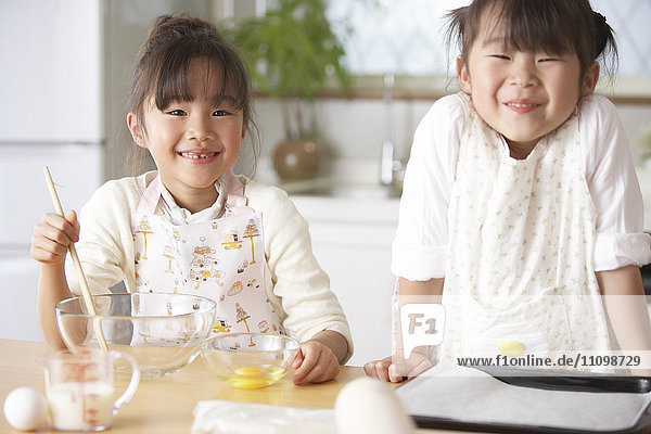 Portrait of girls wearing apron