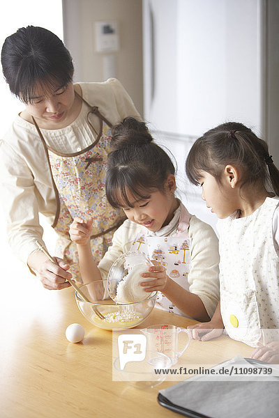 Mother and daughters cooking