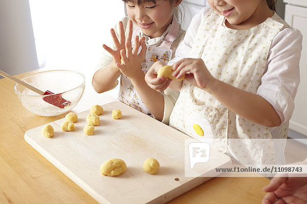Girls kneading bread dough