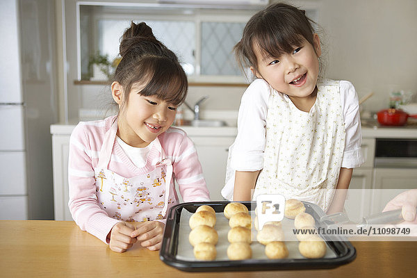 Girls looking at baked bread