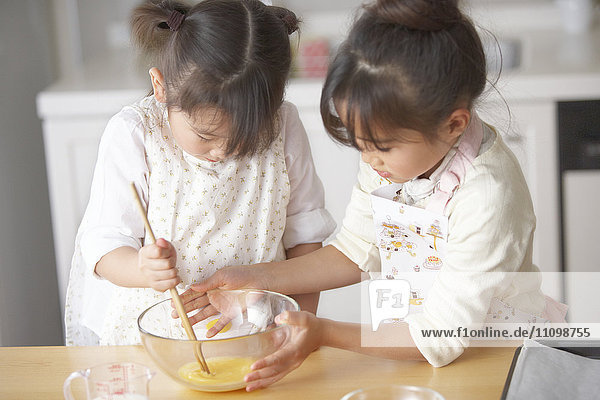 Girls beating egg