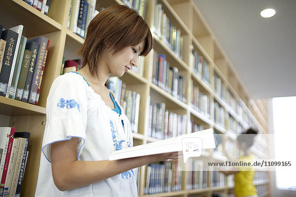 Female student reading at library