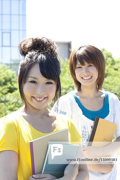 Two female students standing outside