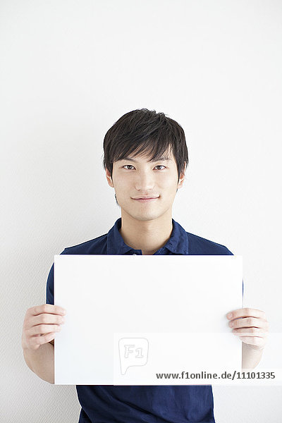 Young man holding a whiteboard
