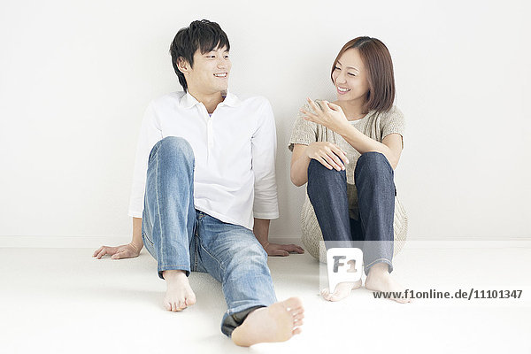 Young couple sitting and smiling