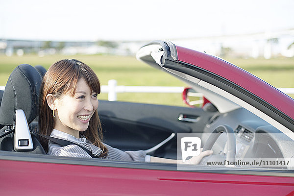 Woman driving a convertible  Fukuoka Prefecture  Kyushu  Japan