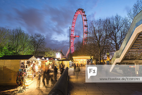 Christmas Market in Jubilee Gardens  with The London Eye at night  South Bank  London  England  United Kingdom  Europe
