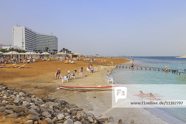 Ein Bokek (En Boqeq) beach with bathers in the turquoise sea and relaxing ashore Dead Sea Israel Middle East