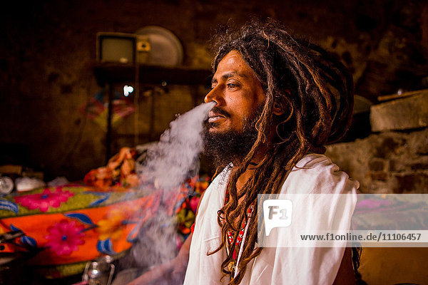 Holy man smoking  Jaipur  Rajasthan  India  Asia