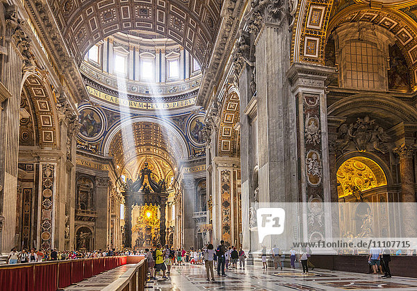 Interior of St. Peters Basilica with light shafts coming through the dome roof  Vatican City  UNESCO World Heritage Site  Rome  Lazio  Italy  Europe