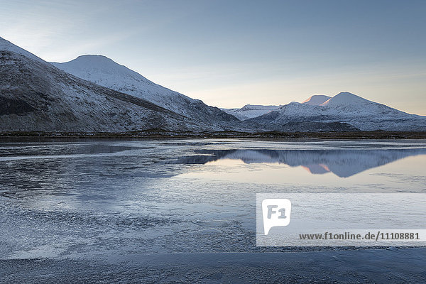 A view of the mountains of Cranstackie and Foinaven from a small lochan near Carbreck  Sutherland  Scotland  United Kingdom  Europe
