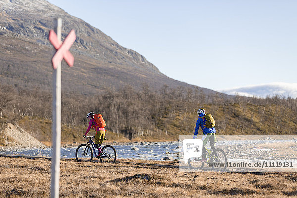 People cycling in mountains