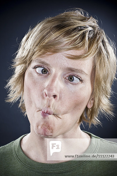 Caucasian woman puckering her mouth