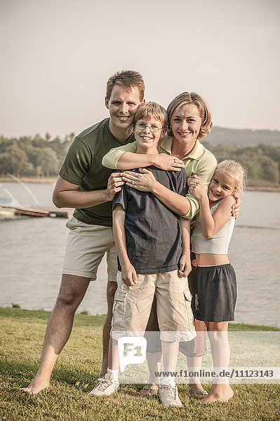 Caucasian family smiling in rural landscape