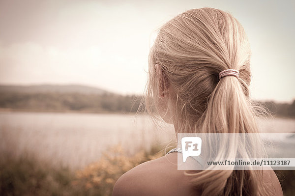 Caucasian girl overlooking rural landscape