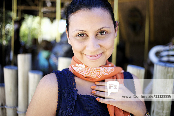 Smiling mixed race woman in scarf