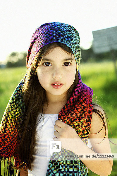 Mixed race girl wearing colorful headscarf