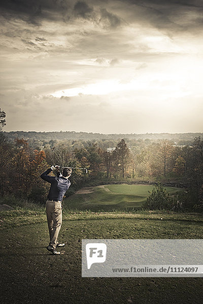 Caucasian man playing golf