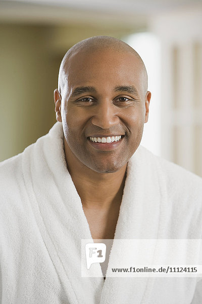 African man smiling in bathrobe