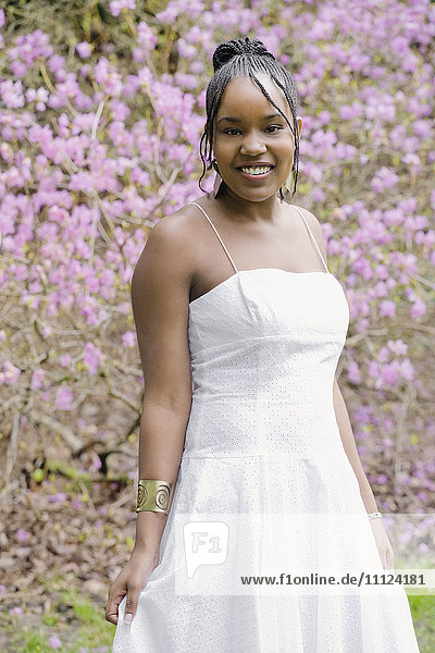 Mixed race woman wearing dress in garden